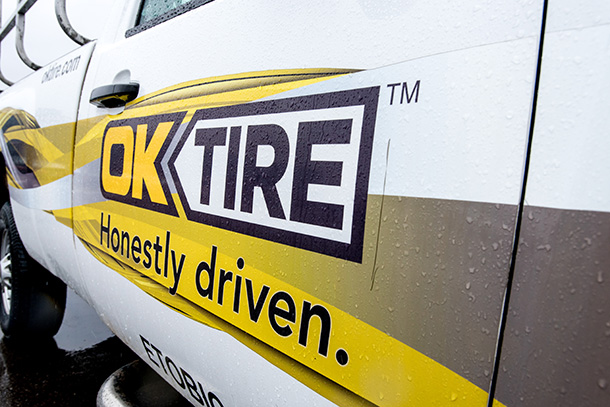 OK TIRE Honestly Driven Logo Closeup on Repair Truck