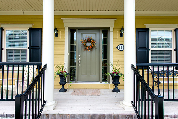 Front of New Amherst Home in yellow with white columns