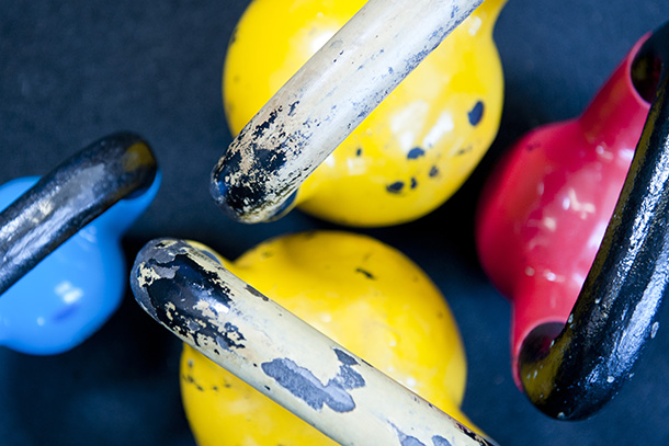 Closeup of yellow, red and blue kettlebell