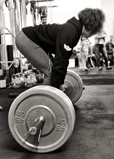 Female participant sideview of powerlifting