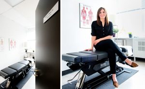 Dr. Lisa Clarke smiles and sits on her chiropractor table