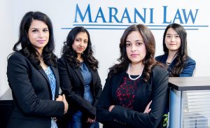 The Marani Law Team with Marani Law Logo in the background
