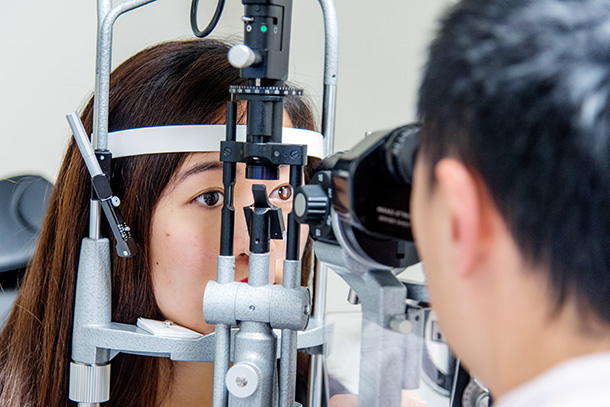 Ophthalmologists Vincent Lam performs an eye examination