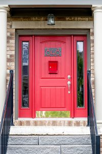 Front door of New Amherst Home in red with dark trim
