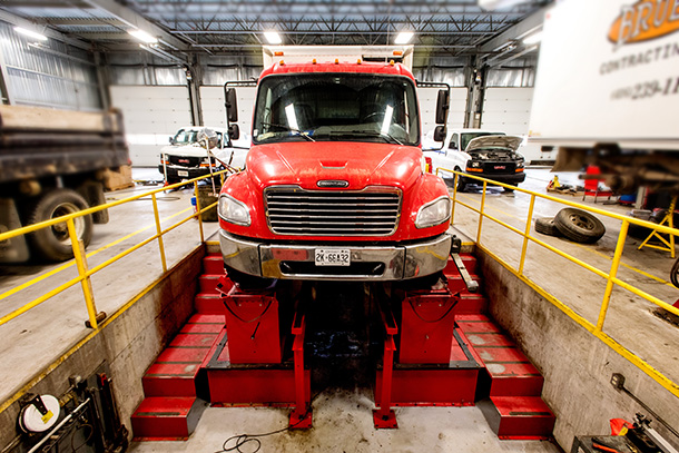Red Truck inside Auto Shop Repair Pit