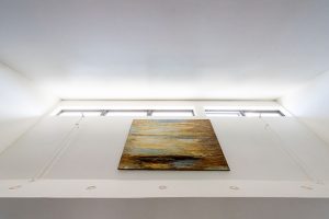 Looking up at artwork and row of skylights