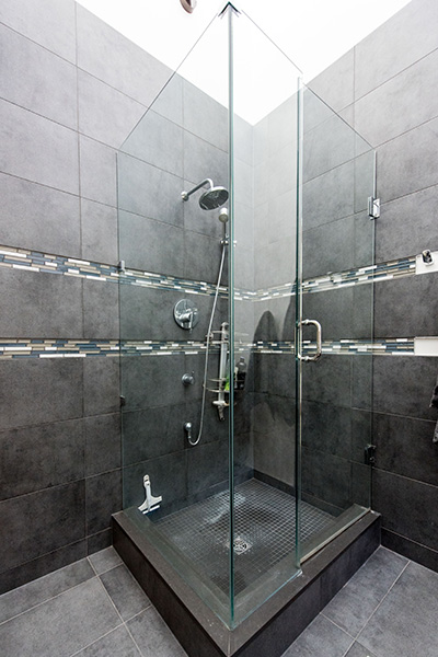 Stand up shower with grey tiles