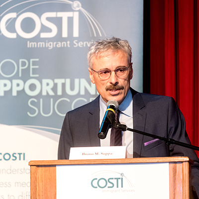 Closeup of Mario Calla, Executive Director of Costi at the podium