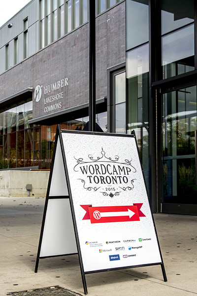 Welcome to WordCamp Toronto, sign outside with red and white arrow