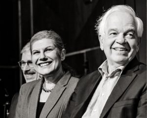 Closeup of John McCallum, Laura Albanese and Mario Calla smiling on stage