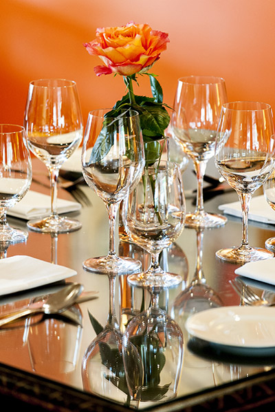 Closeup of Dining Table Setting with Orange Flower