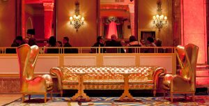 Gold couches and sitting chairs, guests enjoy meals