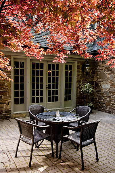 Outside patio seating with double doors in background