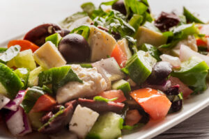 close up food photograph of Greek salad on a white plate.